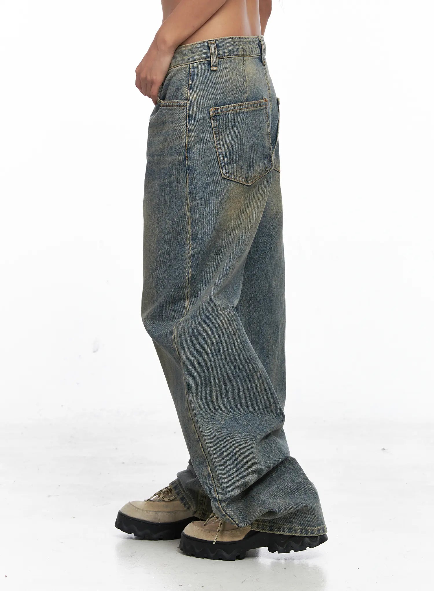 Denver Vintage Washed Semi-Wide Jeans CO513 in blue, side view on model showing back pocket detail, relaxed wide-leg cut, vintage amber-washed cotton denim, styled with chunky sneakers.