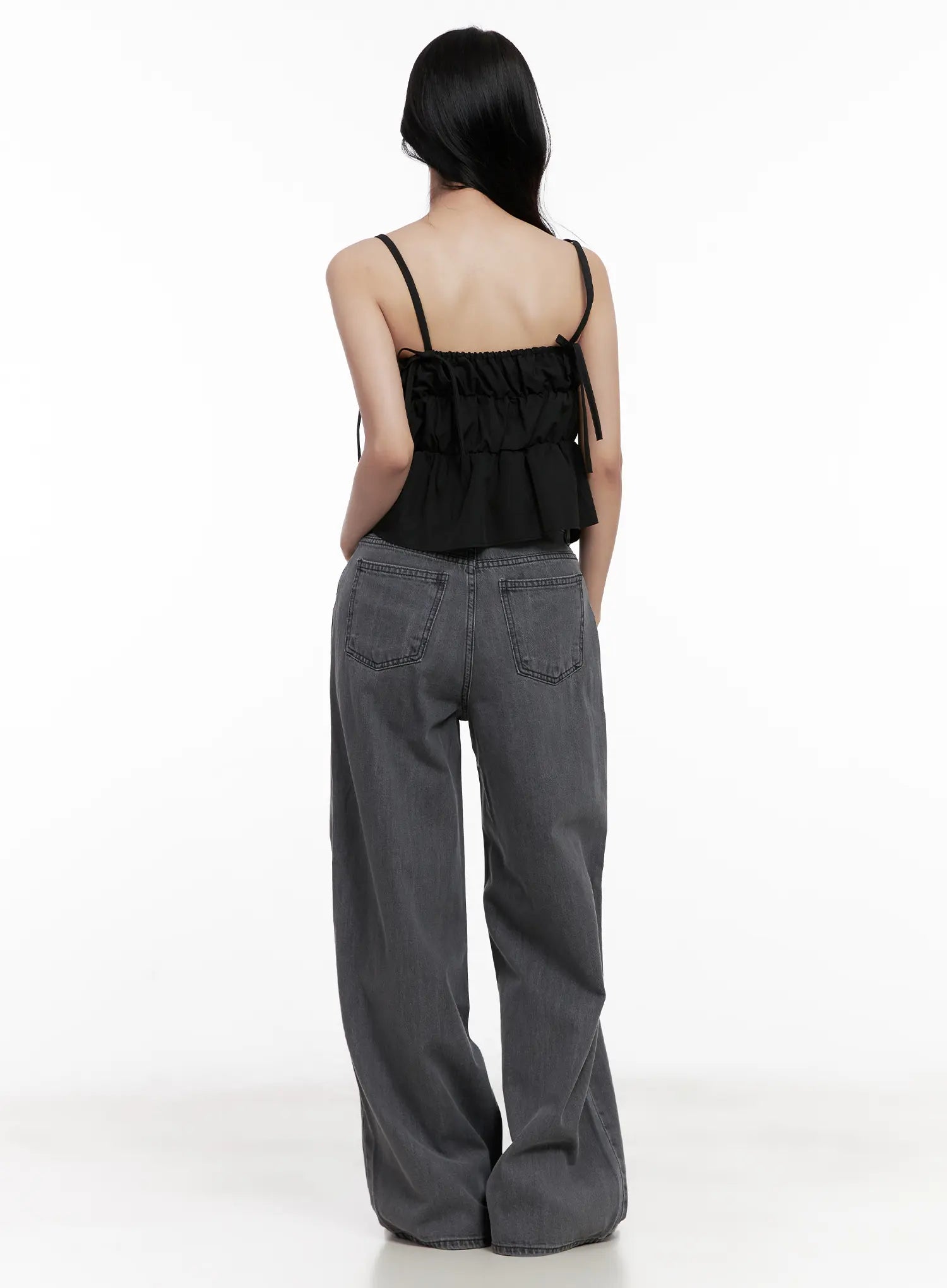 Jiyeon Dark Gray Denim Jeans CL516 in dark gray, back full-body view on model, showing patch back pockets and wide-leg drape, styled with black ruffled cami top.