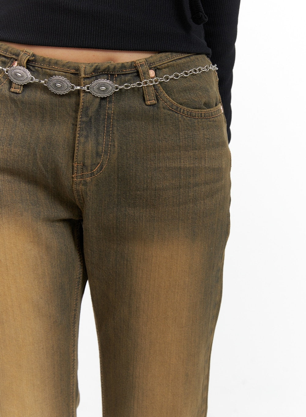 Vintage Washed Flared Jeans CM411 in dark blue, close-up of waistband and front pockets on model, vintage brown-toned washed denim with silver concho chain belt detail.