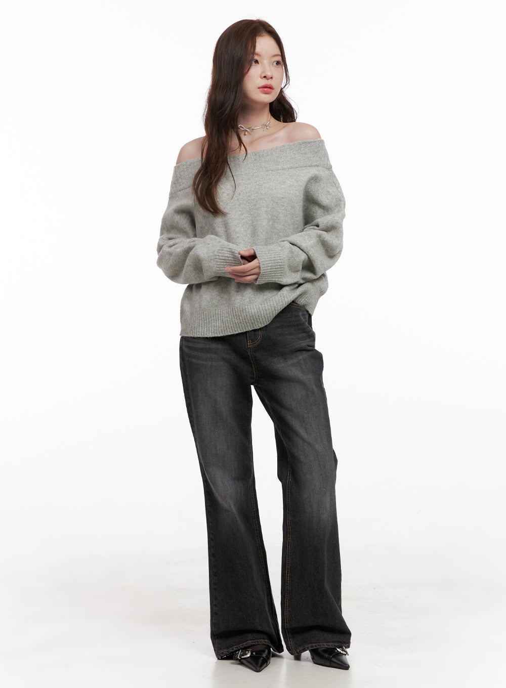 Kiana Cotton Wide Fit Flared Jeans OD403 in black, three-quarter front angle on model, high-rise washed cotton flared jeans, paired with grey off-shoulder oversized knit top and black heels.