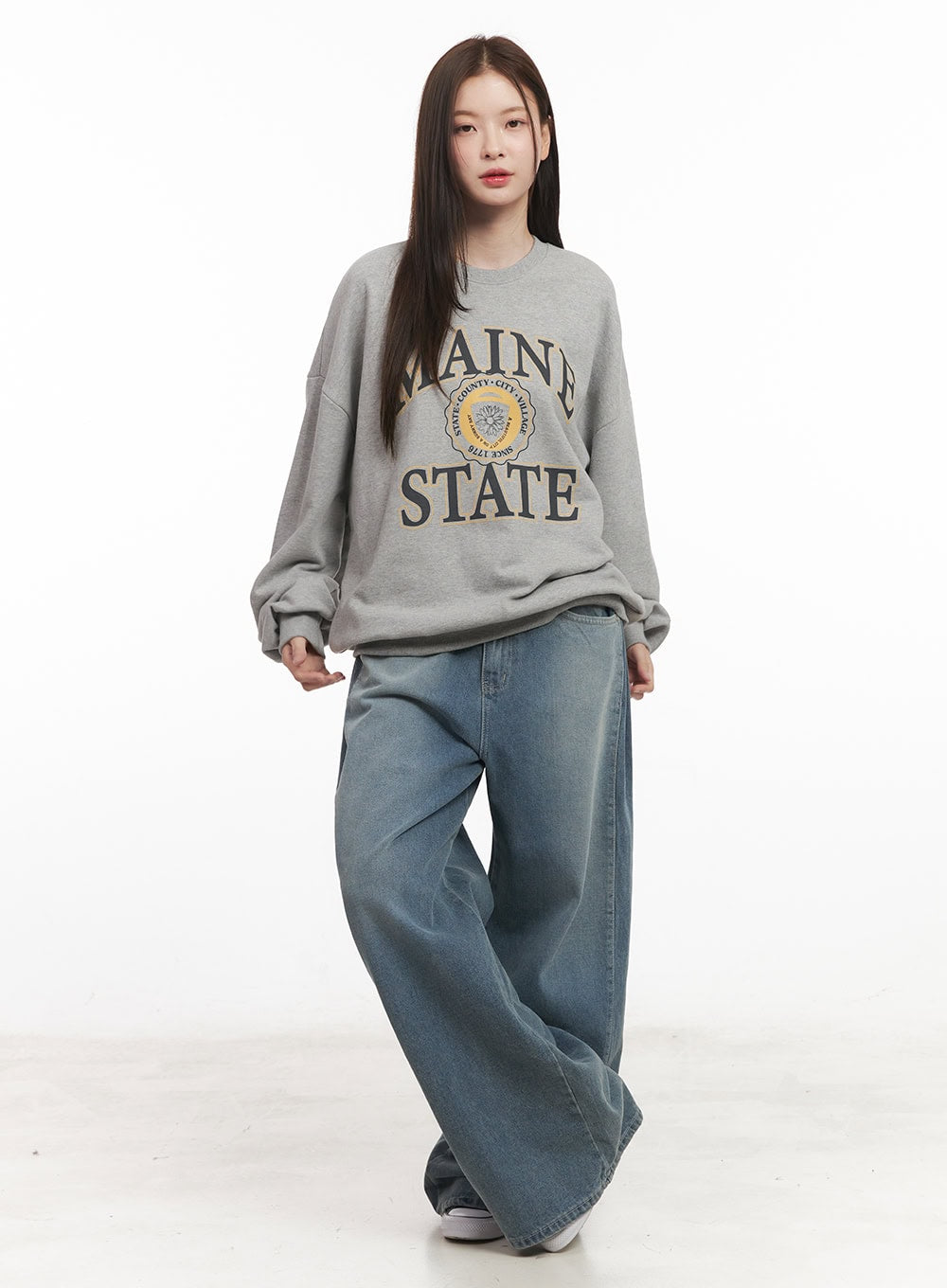 Amber Pintuck Wide-Leg Jeans CM511 in blue, full-body front close view on model, wide-leg washed denim with pintuck, paired with grey college sweatshirt.