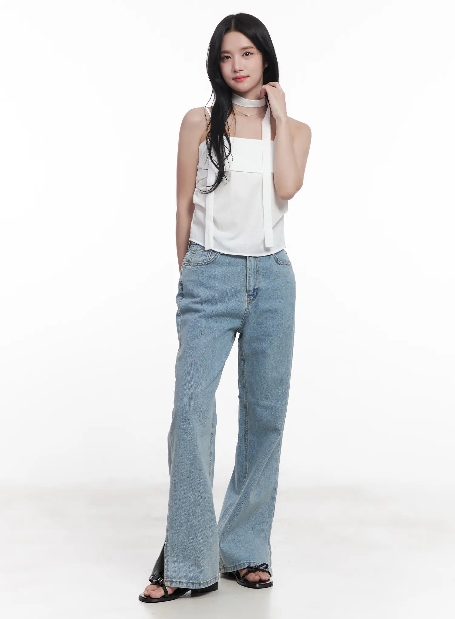 Hyuna Slit Straight-Fit Jeans CU525 in light blue, full-length front view on model, wide-fit washed cotton denim with hem slit detail, paired with white halter top and black sandals.