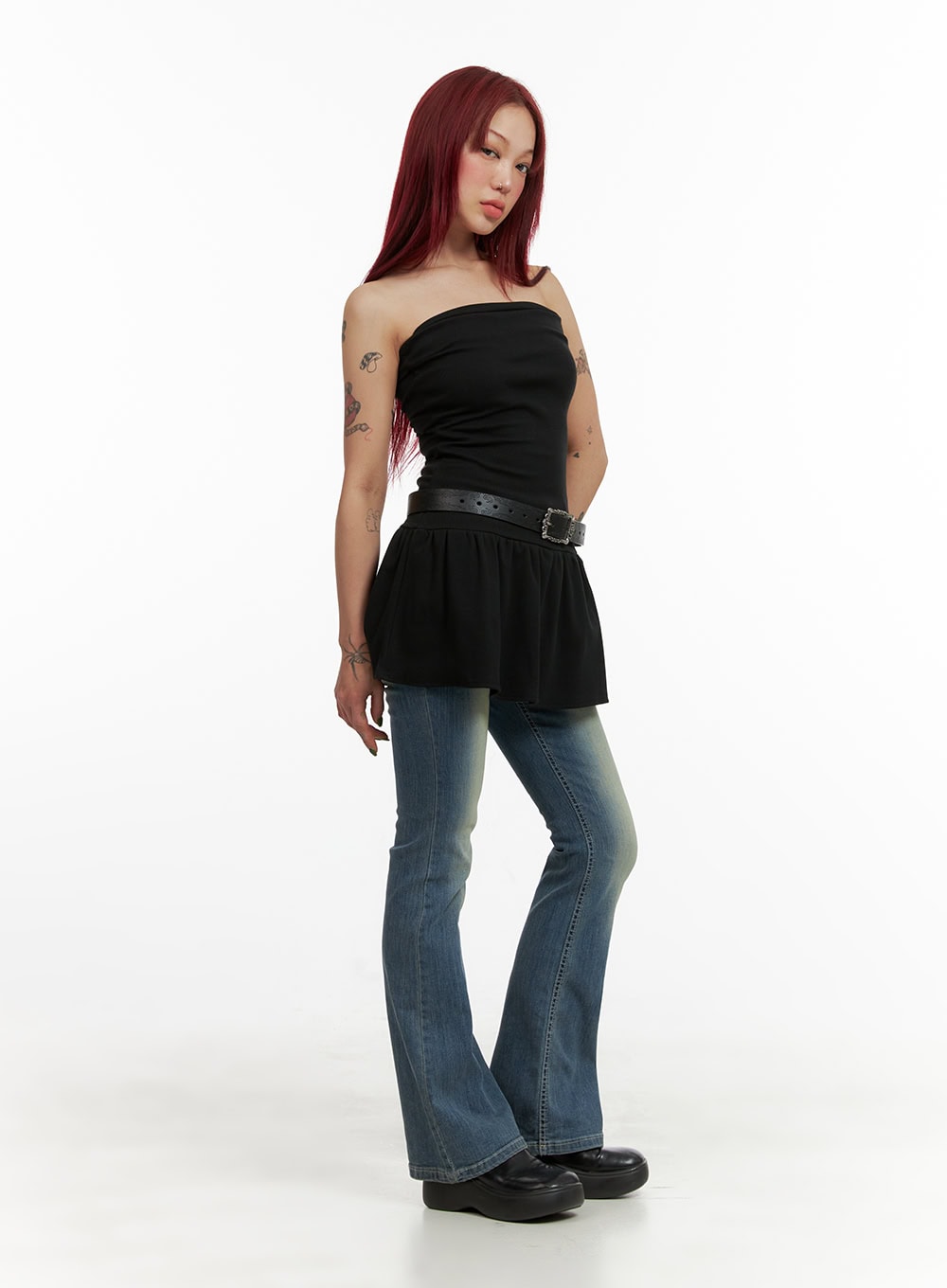 Washed Slim Bootcut Jeans CY429 in blue, side-angle full-body shot on model, slim fit through thigh flaring at hem, styled with black strapless belted top.