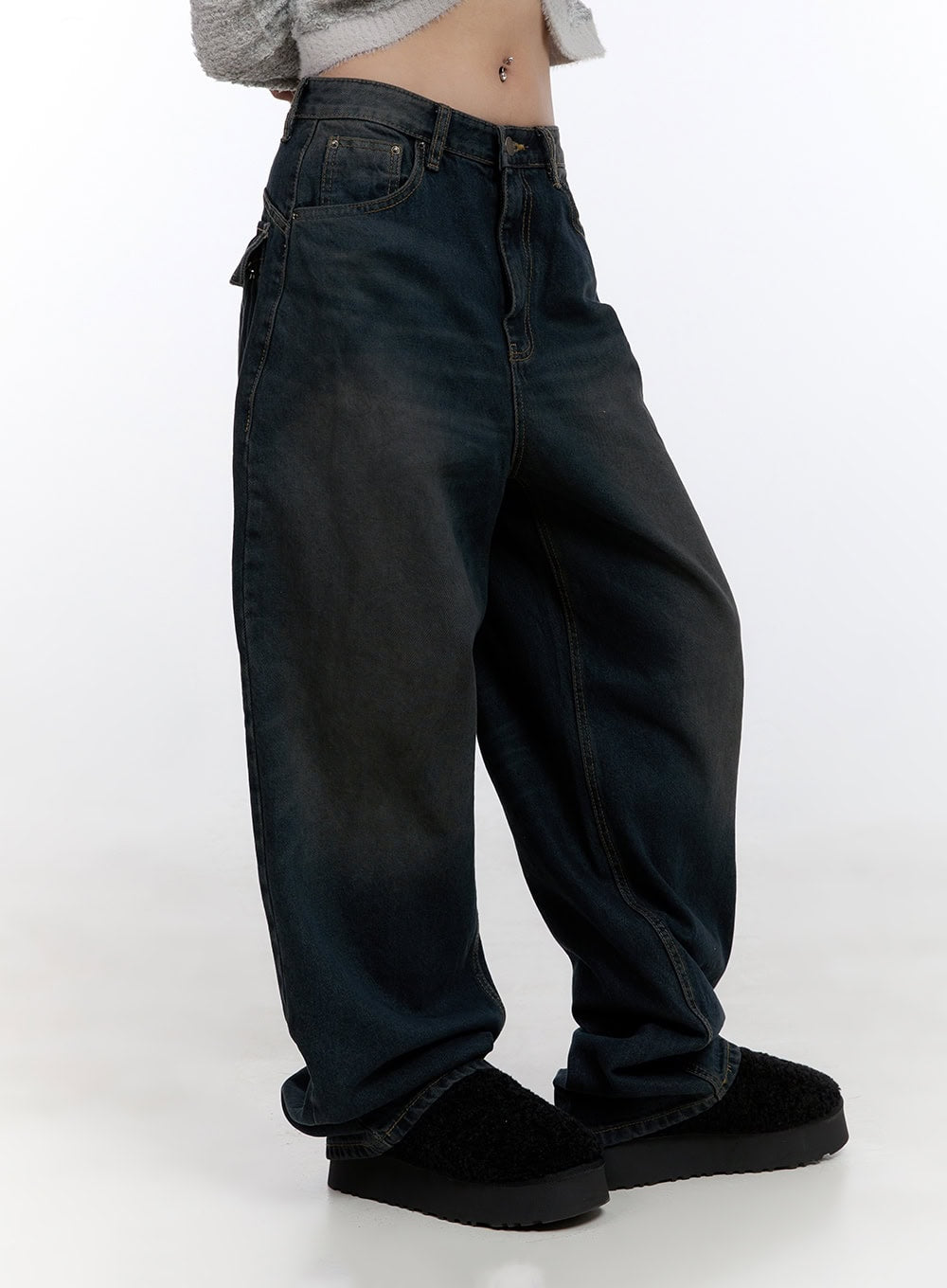 Lyla Wide Leg Jeans CO423 in dark blue, side view on model, oversized baggy silhouette with washed denim, visible side pocket detail, hem pooling over black shearling shoes.