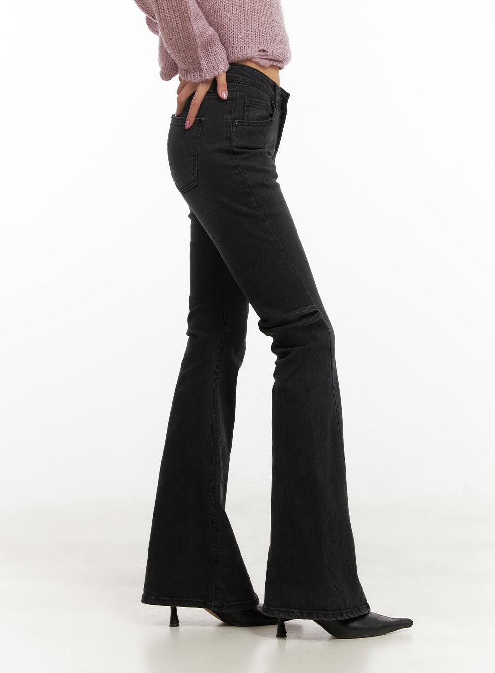Belle Slim Fit Flared Jeans CD410 in black, side view on model, slim fit through hip with dramatic flared leg, washed denim, paired with pink knit and black kitten heels.
