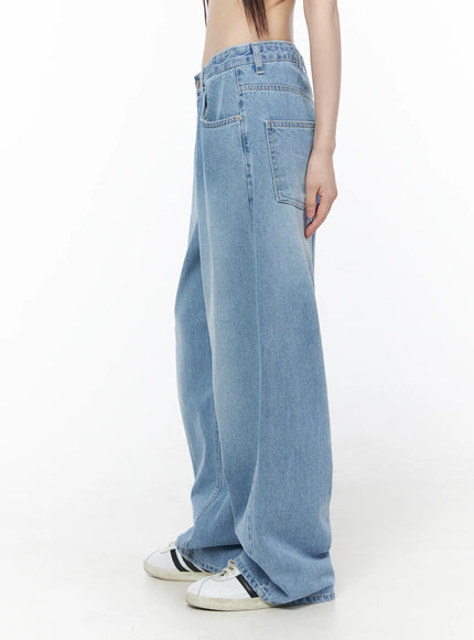 Nella Wide Leg Jeans CU519 in blue, side view on model, light-wash denim showing patch pocket detail and relaxed wide leg fit, with white sneakers.