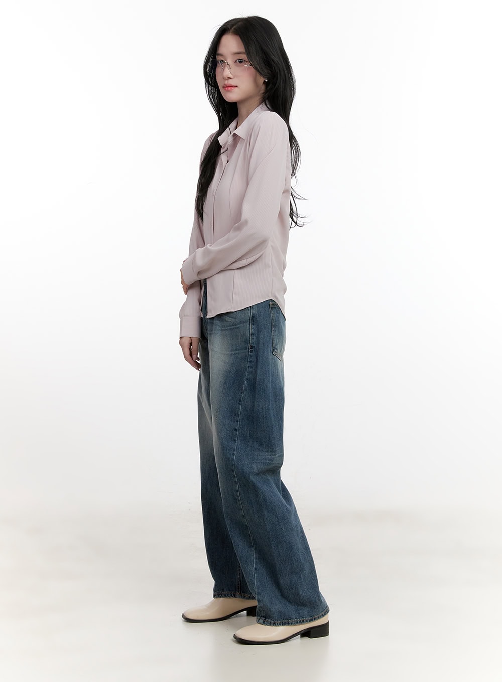 Belle Washed Wide-Leg Jeans CF528 in blue, side view on model, wide-leg washed denim with subtle fading, paired with pink long-sleeve shirt and cream block-heel boots.