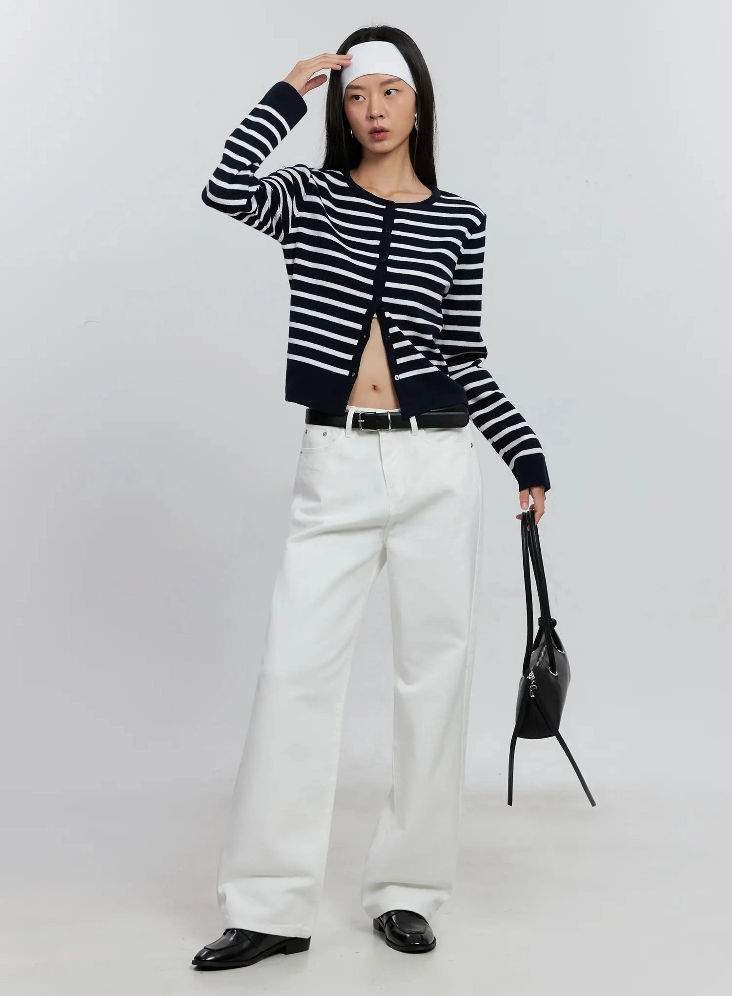 Taytum Straight-Leg Jeans IS515 in white, full-body angled view on model, straight-leg cotton denim with black belt, styled with striped cardigan, headband, and black bag.