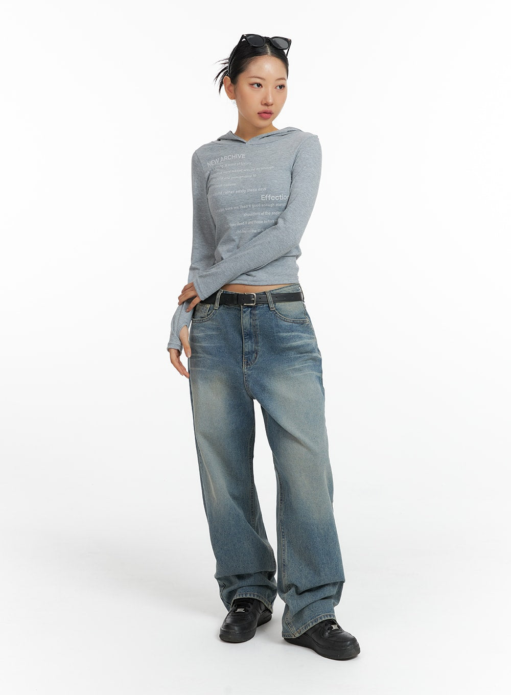 Washed Denim Wide-Leg Jeans CF419 in mid blue, full-body front shot on model, petite wide-leg silhouette with vintage fade, styled with grey graphic hoodie and black sneakers.