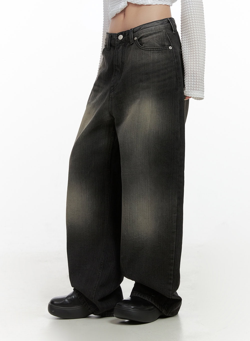 Sage Back-Buttoned Wide Pants CS430 in black, side angle close-up on model, washed cotton denim with golden fade at thigh, exaggerated wide leg pooling at hem, paired with white waffle crop top.