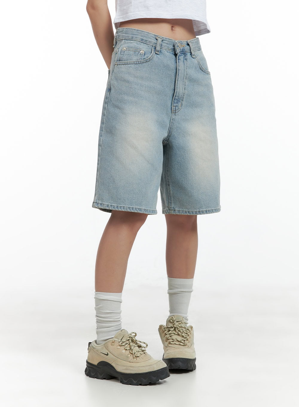 Light Washed Jorts CL417 in light blue, side-angle waist-down shot on model, wide-fit washed denim shorts showing side seam silhouette and knee-length hem, styled with chunky sneakers.