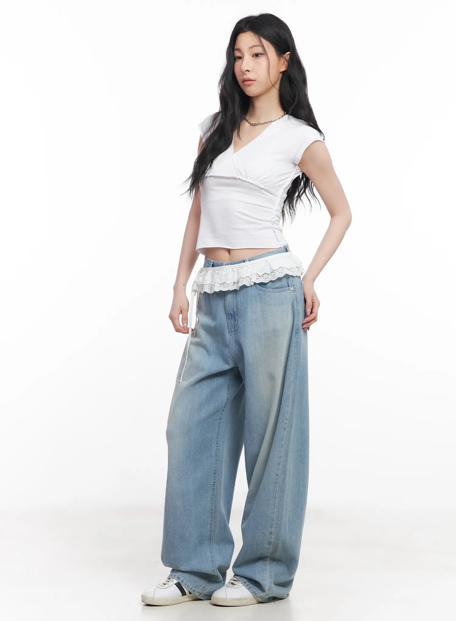 Rose Washed Baggy Summer Denim Jeans CU511 in light blue, three-quarter side view on model, wide-fit washed denim paired with white wrap crop top and lace ruffle skirt layer over waist.