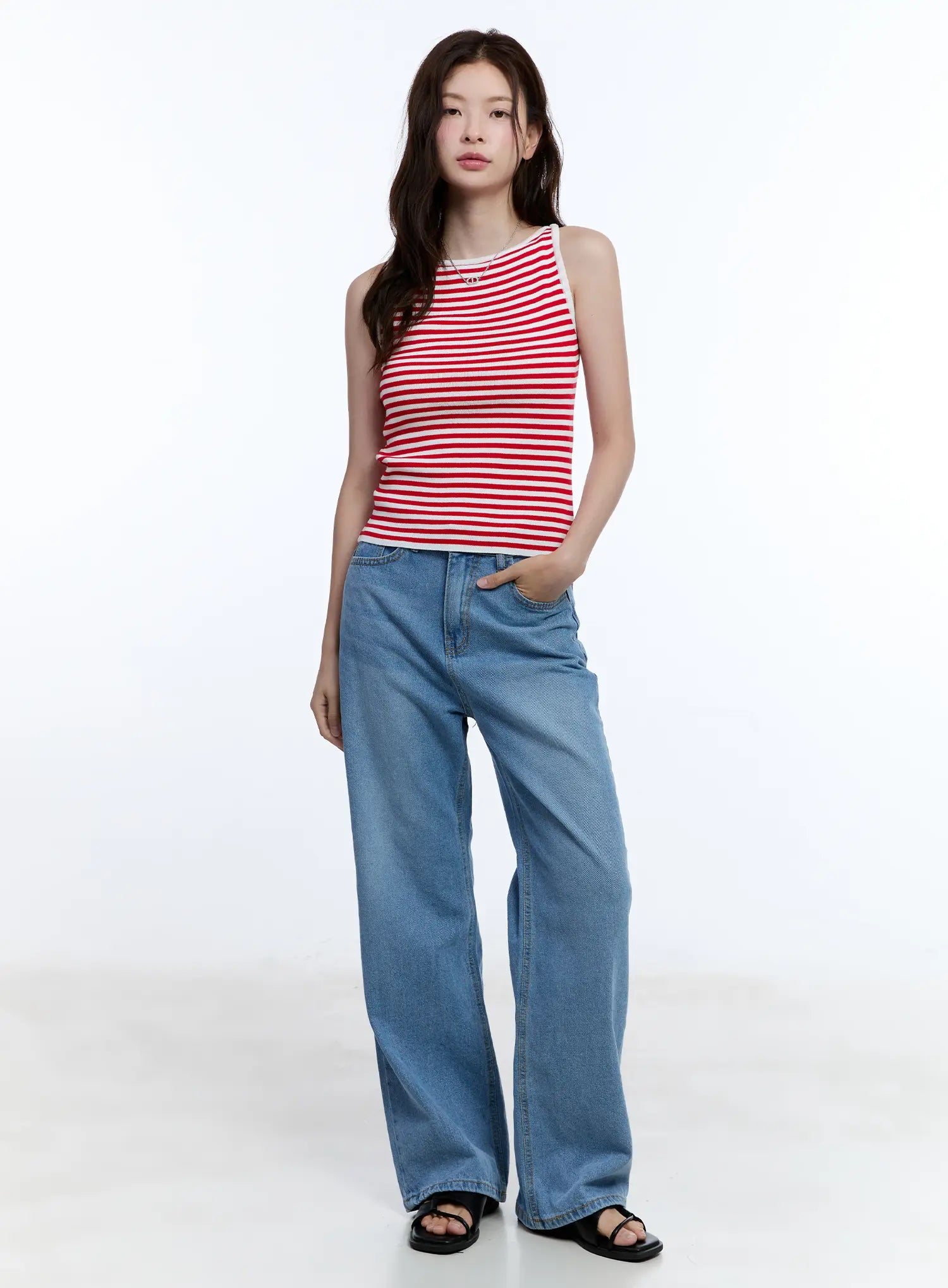 Jisoo Straight-Fit Jeans CU513 in blue, full-body slightly angled front shot on model, wide-fit washed denim, paired with red striped sleeveless top and black sandals.
