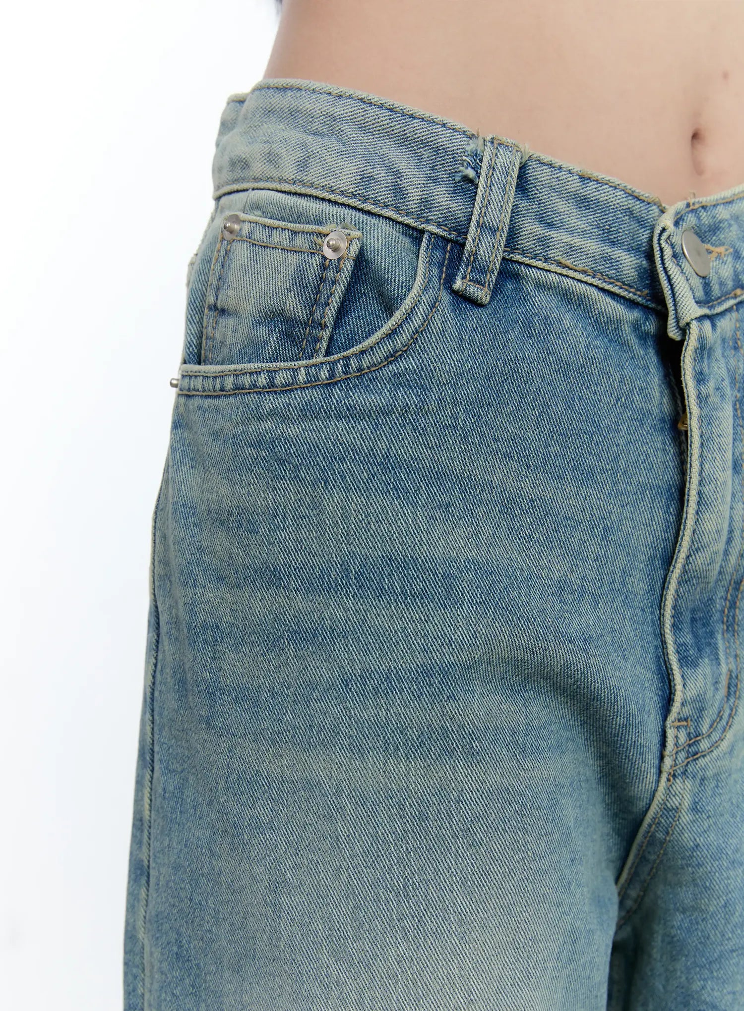 Haeun Wide-Leg Denim Jeans CG501 in blue, close-up detail of front waistband and coin pocket, showing washed cotton denim texture, rivets, and V-shaped low-rise waistline.