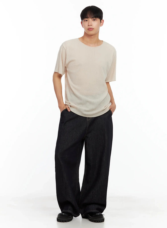 Men's Dark Denim Baggy Jeans IL516 in dark blue, full-body front on model hands in pockets, voluminous wide-leg fit, styled with beige ribbed tee and chunky loafers.