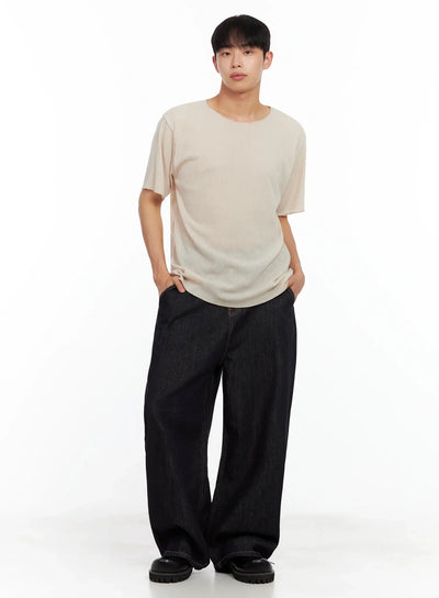 Men's Dark Denim Baggy Jeans IL516 in dark blue, full-body front on model hands in pockets, voluminous wide-leg fit, styled with beige ribbed tee and chunky loafers.