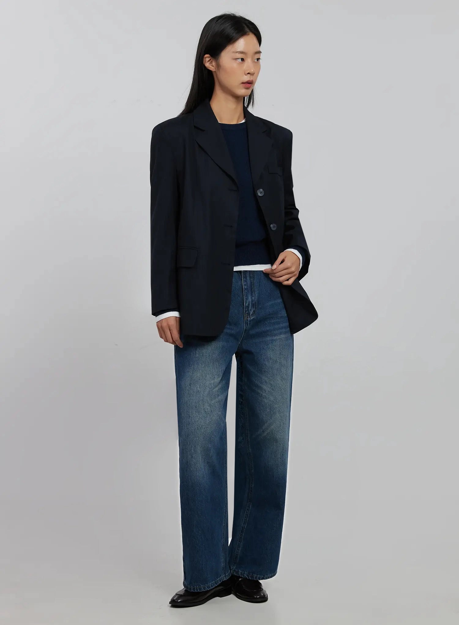 Alaina Wide Leg Jeans IJ508 in dark blue, full-length side view on model wearing navy oversized blazer and layered knit, long wide-leg silhouette to ankle.