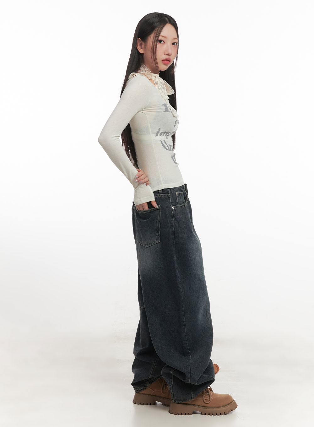 Giselle Stitched Balloon-Fit Jeans CF526 in dark blue, side view on model showing voluminous balloon silhouette and panelled knee seam, paired with cream graphic top and brown boots.