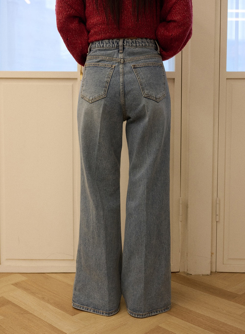 Casual Denim Solid Straight Leg Jeans OD326 in blue, back view on model, rear patch pockets with contrast stitching, washed cotton wide-leg silhouette, styled with red knit sweater.