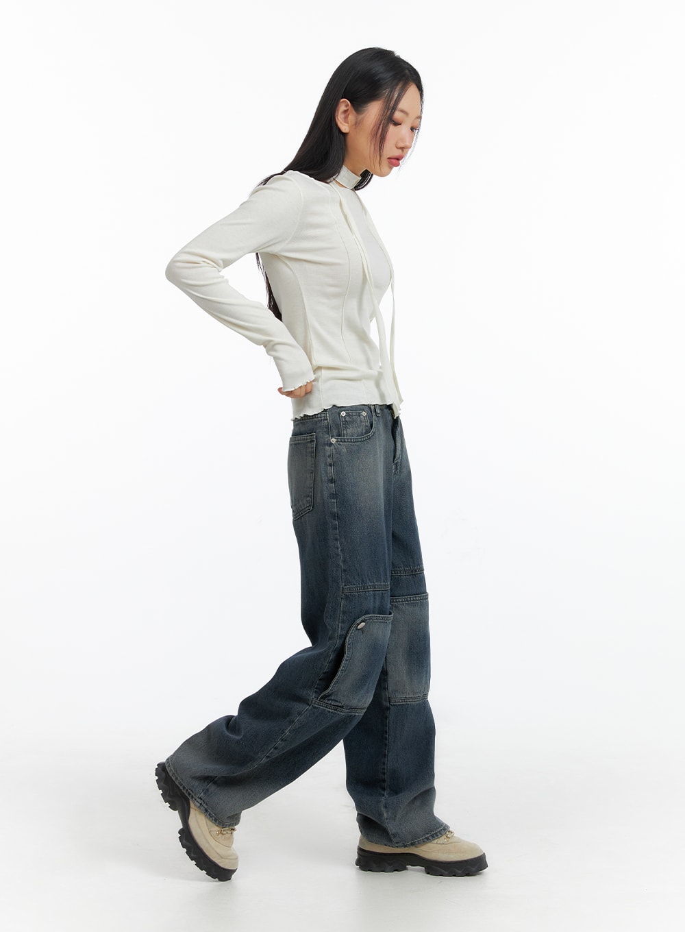 Denim Wide Leg Jeans CF408 in washed dark blue, side walking pose on model, showing paneled leg construction and volume, styled with white fitted top and chunky boots.