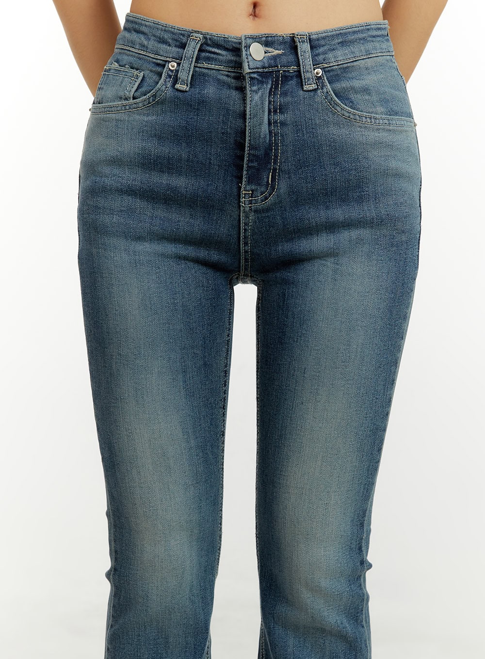 Low Rise Bootcut Jeans CY409 in blue, waist close-up on model, showing low-rise waistband, button fly, five-pocket detail, and washed cotton-spandex fabric.