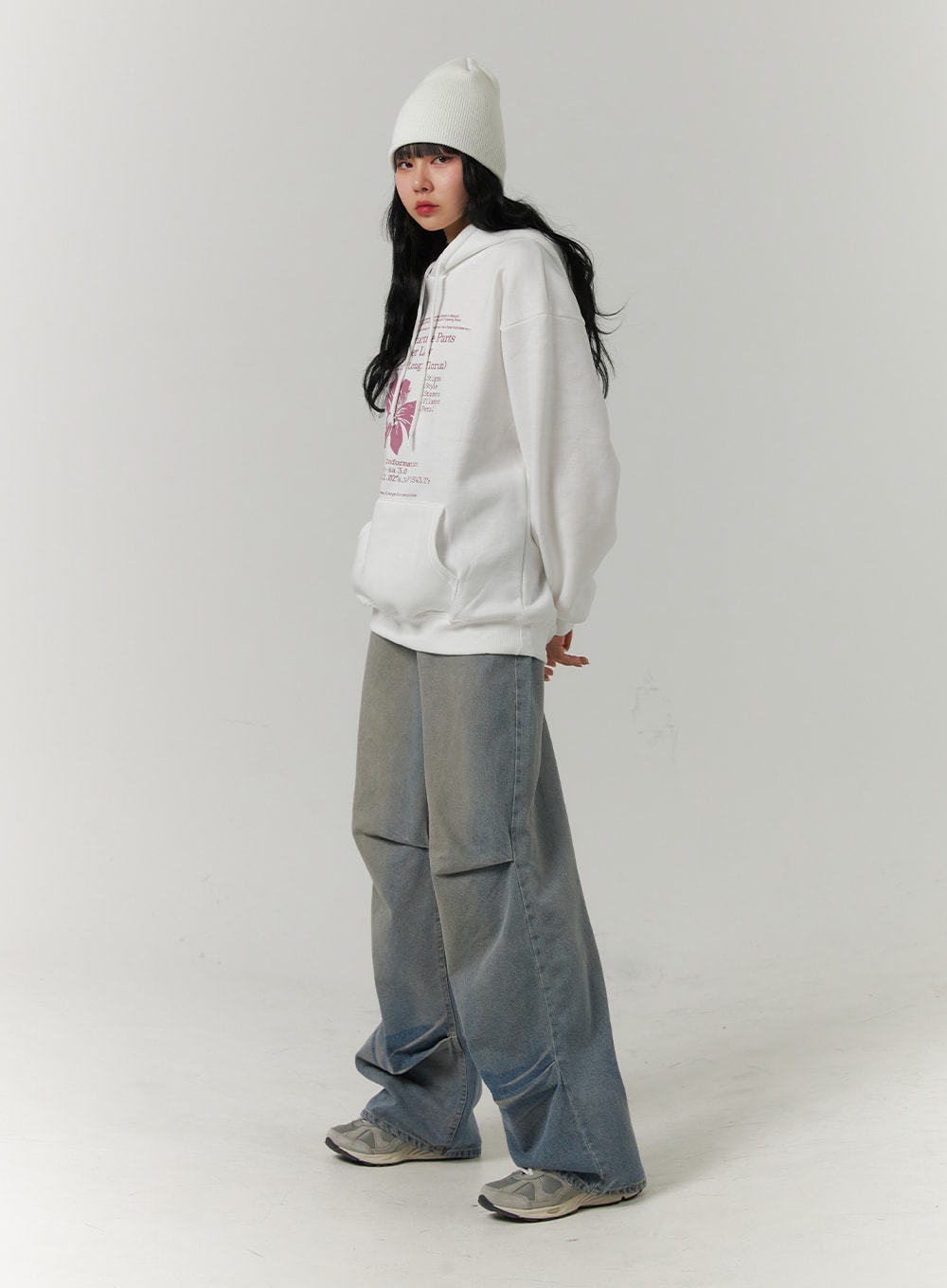 Pintuck Washed Denim Wide-Leg Jeans CJ418 in blue, side-angle full-body view on model, wide-leg cut with visible pintuck at knee, gradient washed denim, styled with white hoodie and grey sneakers.