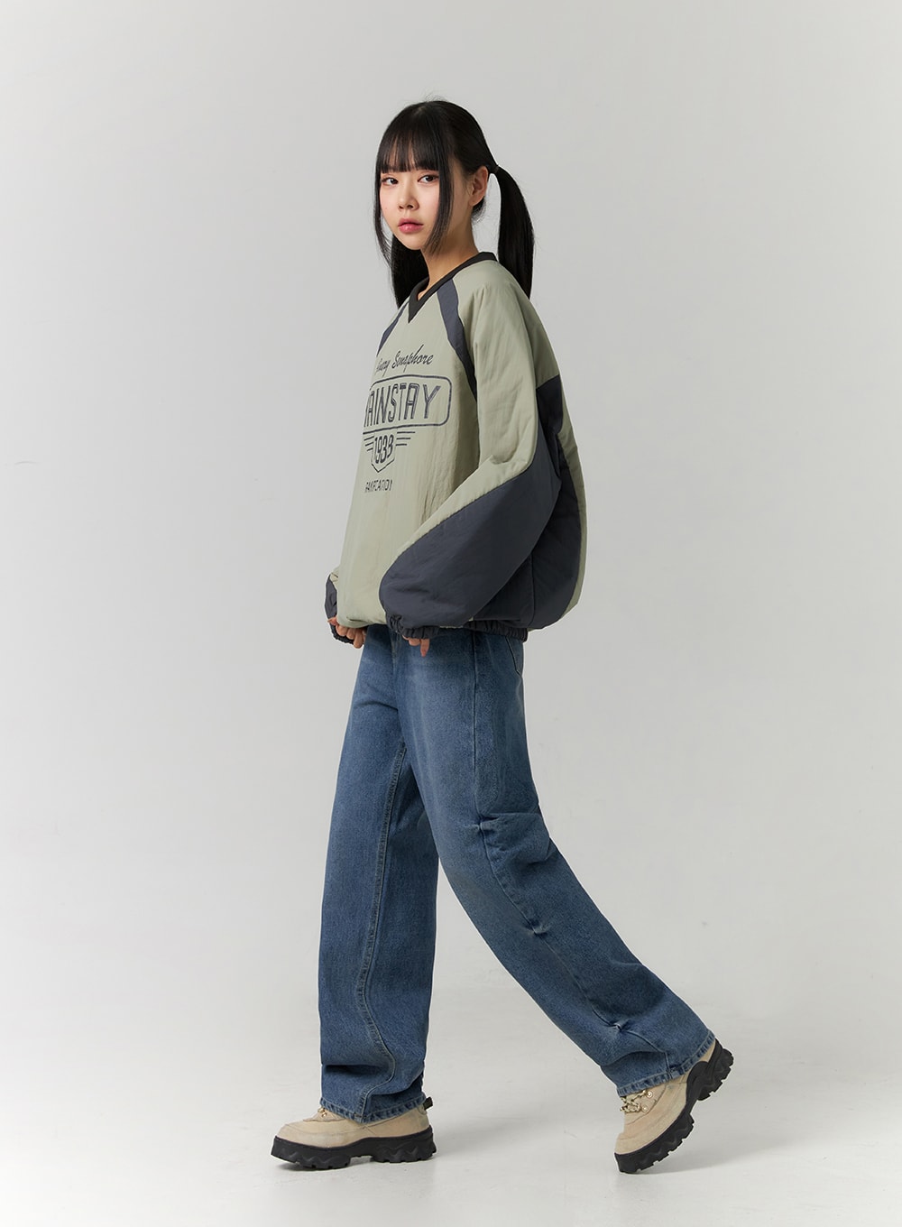 Washed Denim Wide Leg Jeans CD308 in blue, side angled full-body view on model, wide-fit regular-length washed denim, paired with color-block pullover and chunky sneakers.