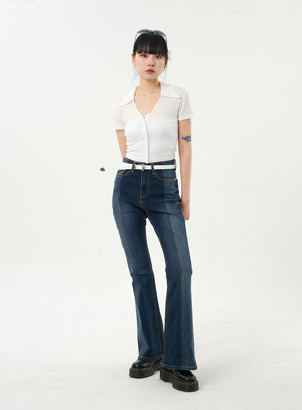 Dark Wash Bootcut Jeans CA328 in dark blue, full-length front view on model facing camera, slim fit washed cotton denim, paired with white crop polo and black platform boots.