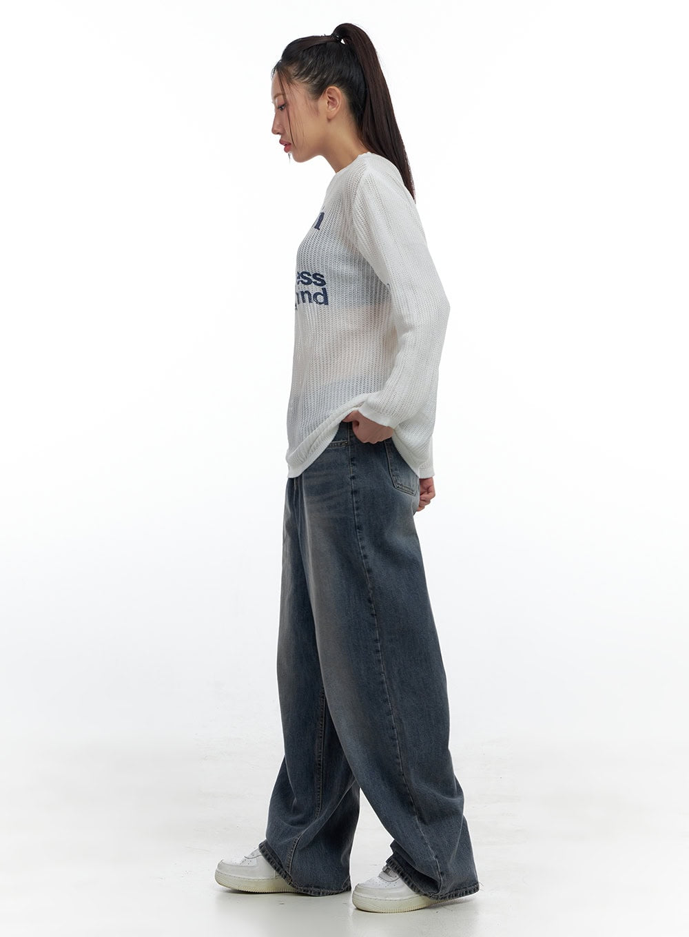 Lana Oversized Wide-Leg Jeans CS425 in blue, side full-length view on model walking, washed denim shows generous wide-leg silhouette and side seam, paired with white graphic knit top.