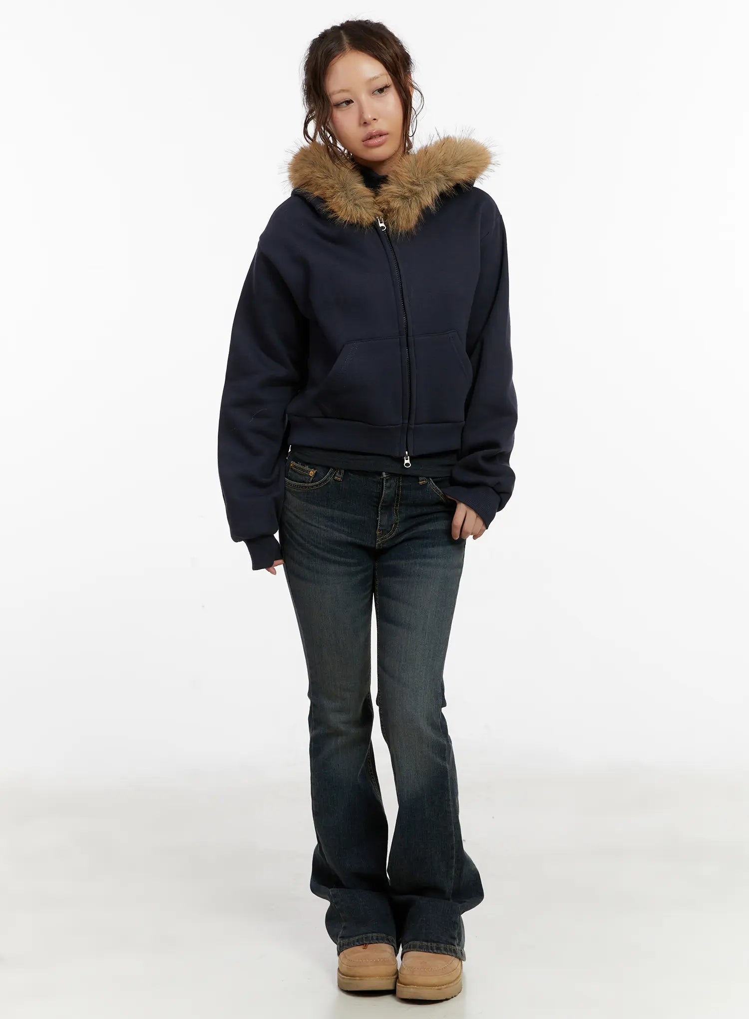 Kai Vintage Washed Flare Jeans CD515 in dark indigo, front full-body shot on model, low-rise bootcut worn with navy fur-trim zip hoodie and tan platform boots.