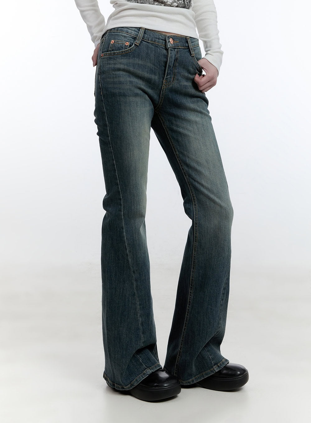Mallory Skinny Bootcut Jeans CJ520 in blue, front three-quarter view on model, slim-fit washed denim showing five-pocket detail and copper rivets, bootcut flare at hem.