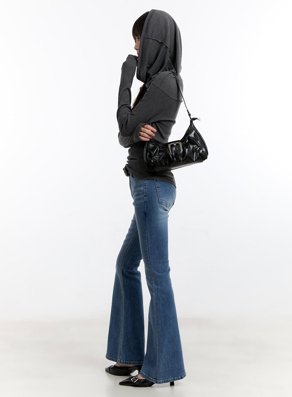 Maris Hip-Pad Bootcut Jeans CA508 in blue, side profile full-length on model, washed slim-fit denim with flared bootcut hem, styled with grey hoodie and black shoulder bag.