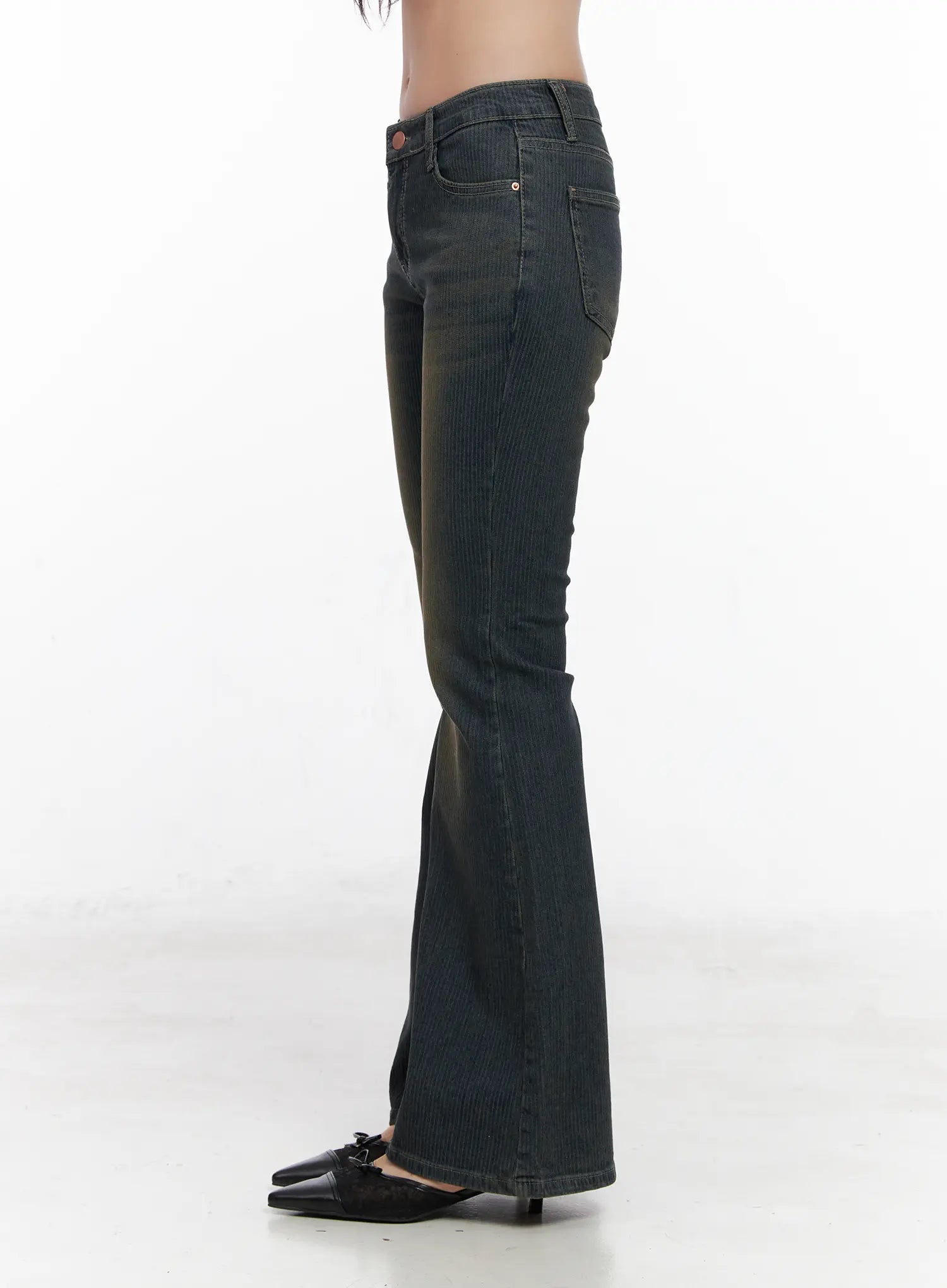 Soleil Hip Pad Stripe Hip Pad Flared Jeans CN512 in dark blue, side view on model, washed vertical-stripe cotton-spandex bootcut silhouette with hip pad, low rise, flared hem, paired with black kitten-heel mules.