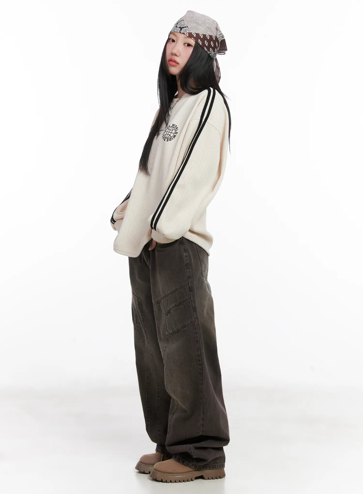 Elia Washed Baggy Jeans CN528 in dark brown, side full-length shot on model, oversized wide leg silhouette with visible cargo pocket, paired with cream stripe sweatshirt.