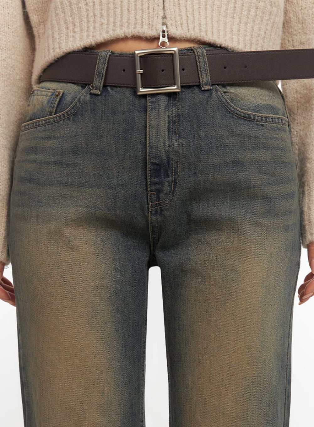 Kourtney Vintage Wash Flared Jeans IF510 in dark blue, close-up waistband detail on model, five-pocket denim with amber vintage wash, brown leather belt with square silver buckle visible.