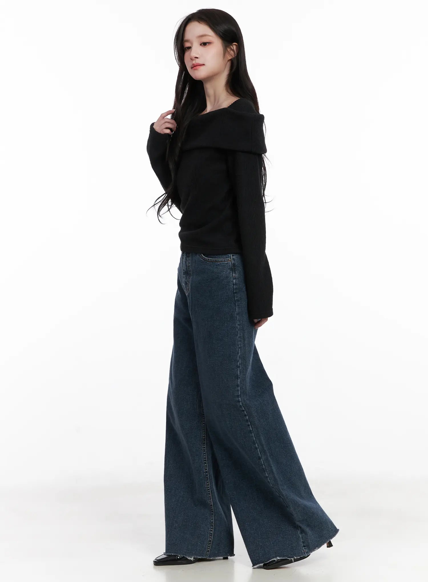 Louisa Ultra Wide Flared Jeans CN527 in dark blue, side view on model, ultra wide flared silhouette showing long inseam and raw hem, paired with black off-shoulder knit, black heeled shoes.
