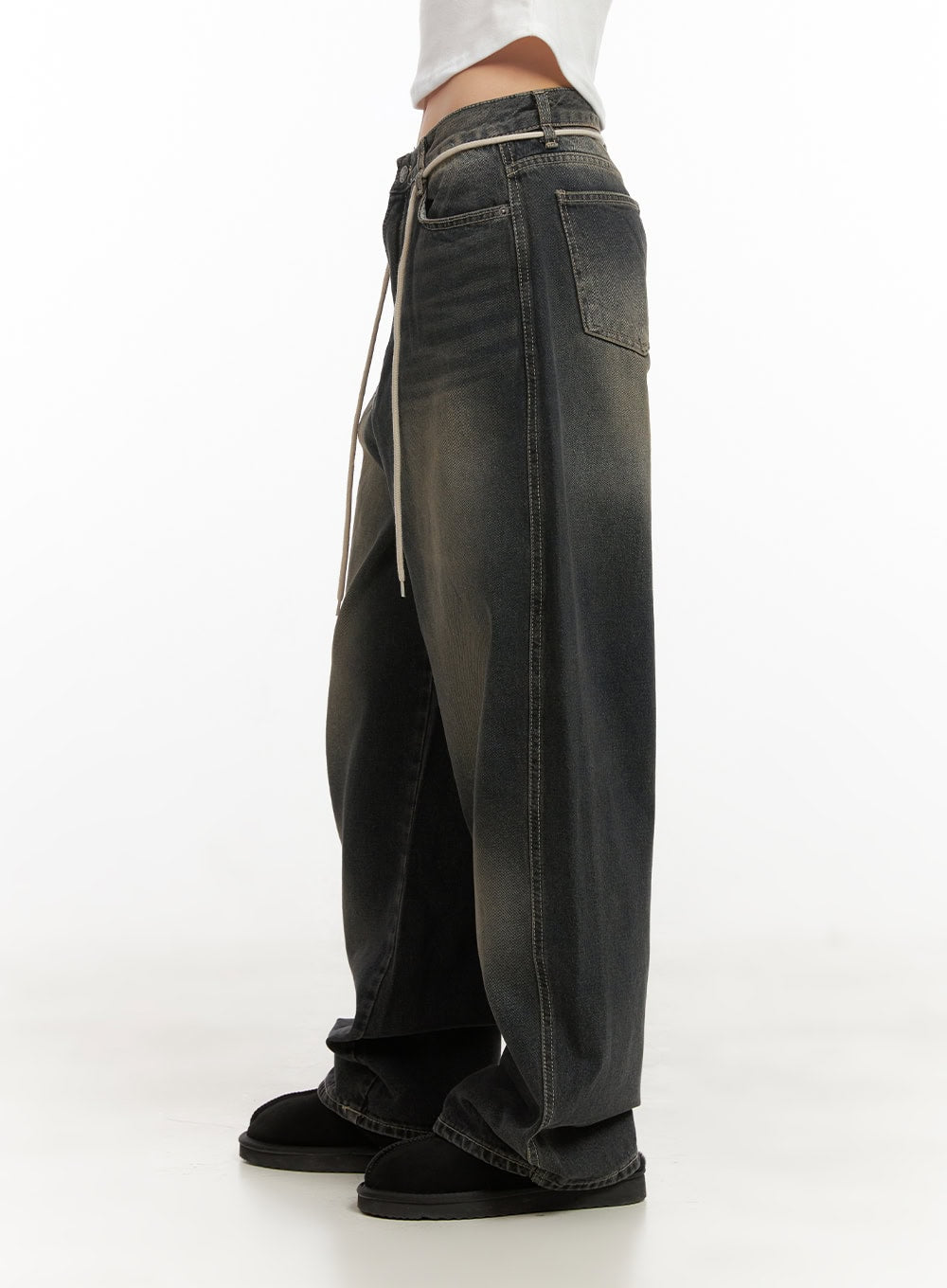 Matilda Washed Denim String Baggy Jeans CD410 in black, side product shot from waist down, showing wide-leg silhouette, back patch pocket, cream string detail along waistband, washed denim texture.