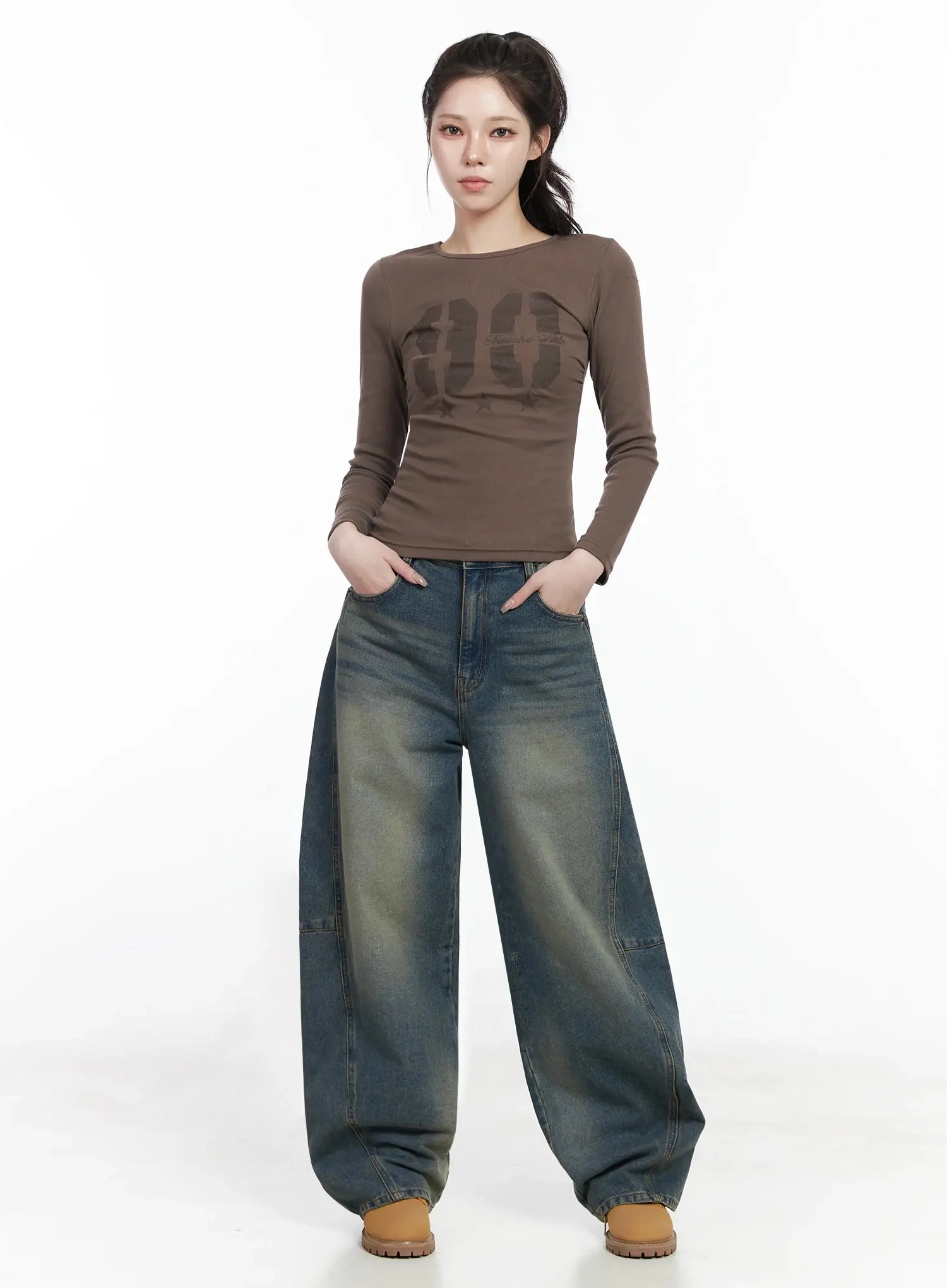 Tata Vintage Dark Blue Washed Wide Leg Jeans IJ528 in dark blue, front full-body shot on model standing straight, voluminous wide leg cotton denim with yellow washed tones, paired with brown graphic long-sleeve top and tan sneakers.