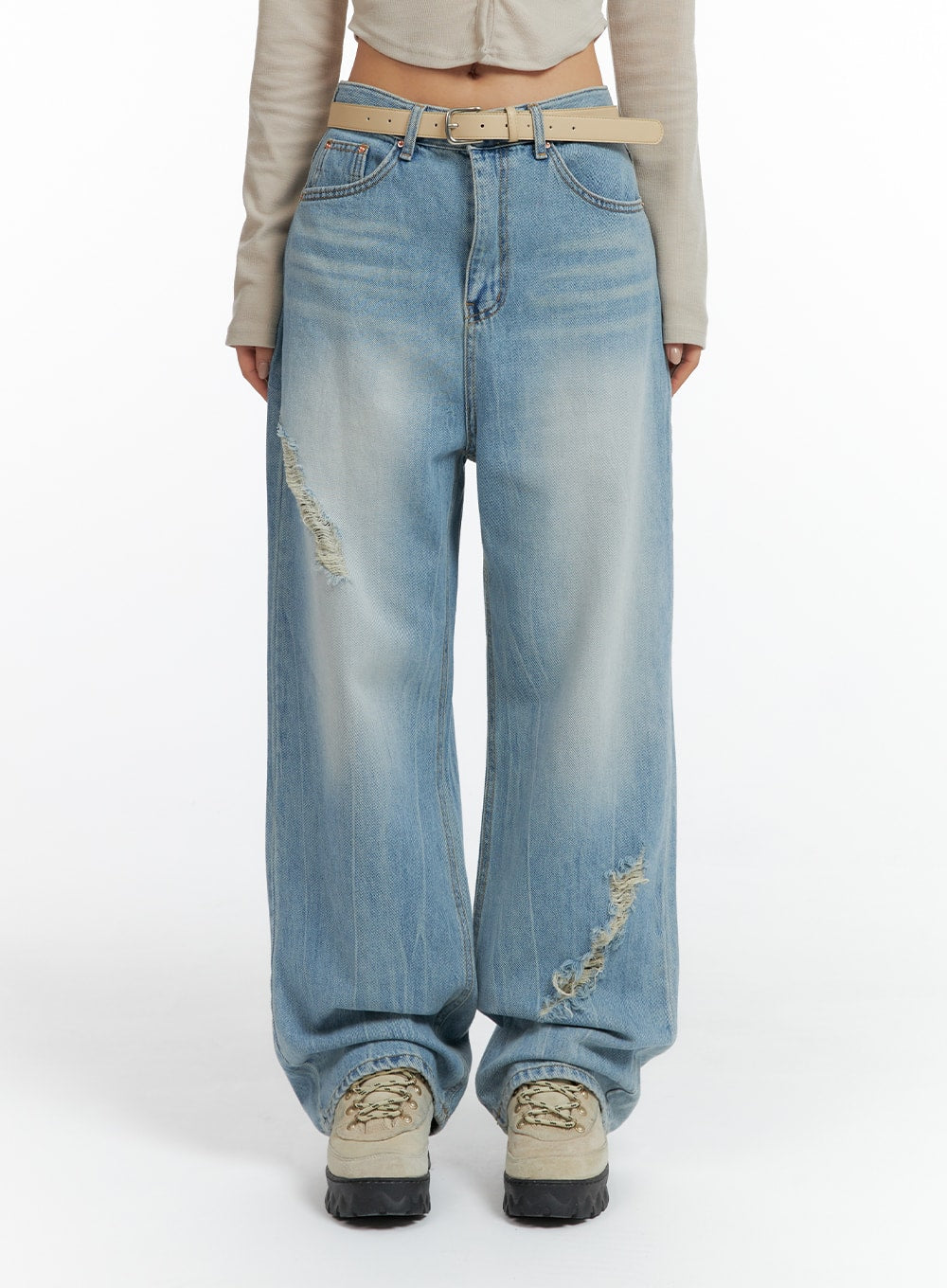 Distressed Wide-leg Jeans CF419 in light blue, front view on model cropped at waist, wide-leg washed denim with diagonal destroyed rips and faded whiskering, tan belt detail.