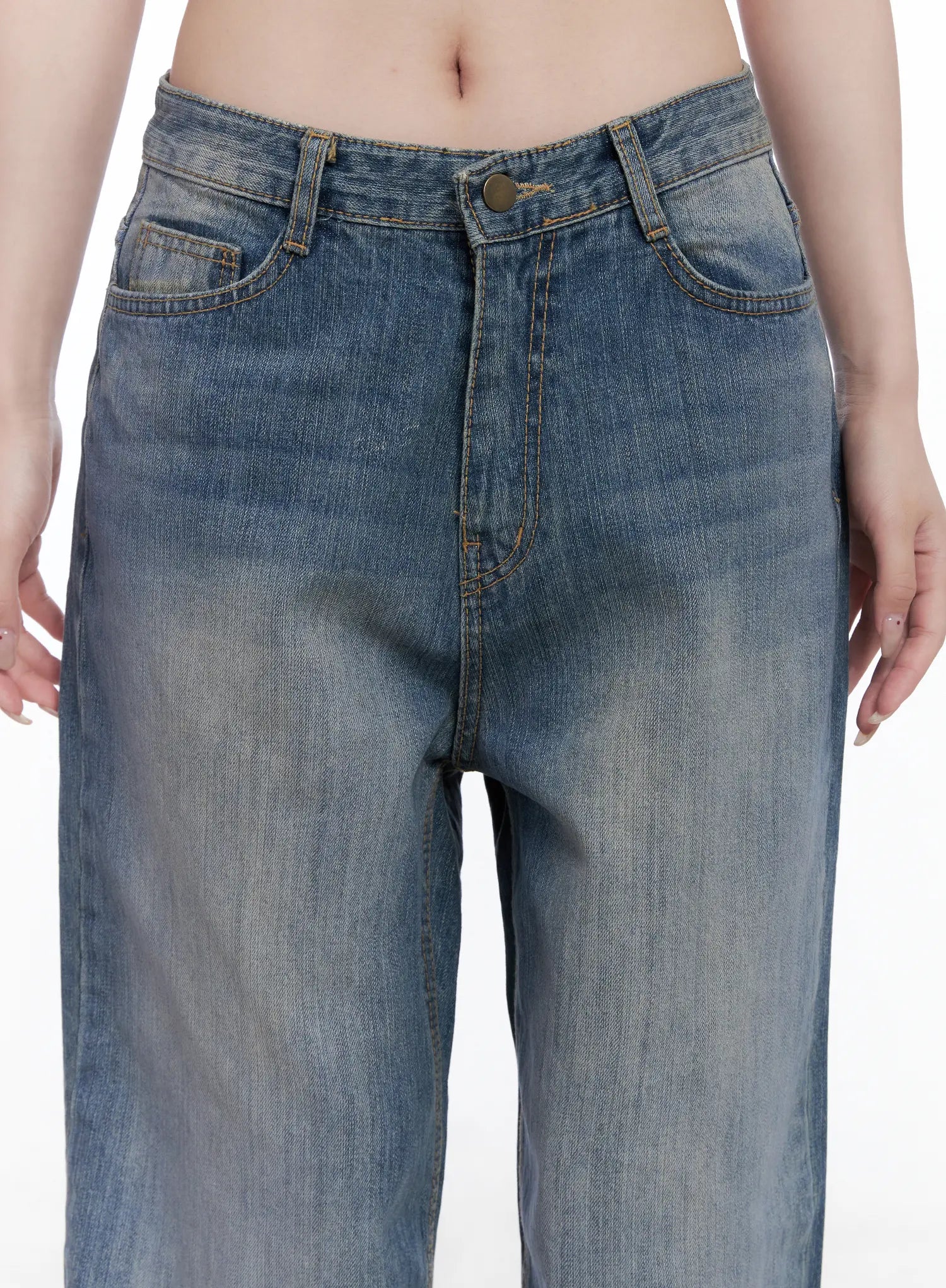 Lala Wide Leg Vintage Washed Jeans CG529 in blue, close-up front detail on model, showing low-rise waistband, front pockets, brass button, and vintage faded wash texture.