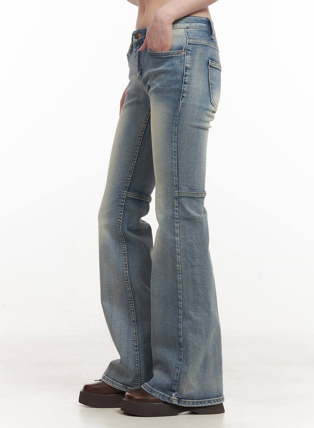 Tracy Washed Bootcut Jeans CF513 in light blue, side view on model with hand in pocket, showing slim fit, washed gradient, panel seam detail, and subtle bootcut flare.