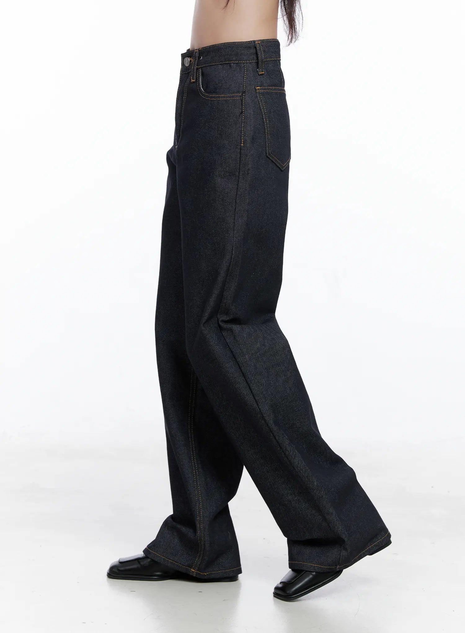 Reyna Non-Fade Relaxed Jeans CS519 in dark blue, side product shot on model, showing wide-leg silhouette, high waist, contrast gold topstitching, and long length pooling at black loafers.