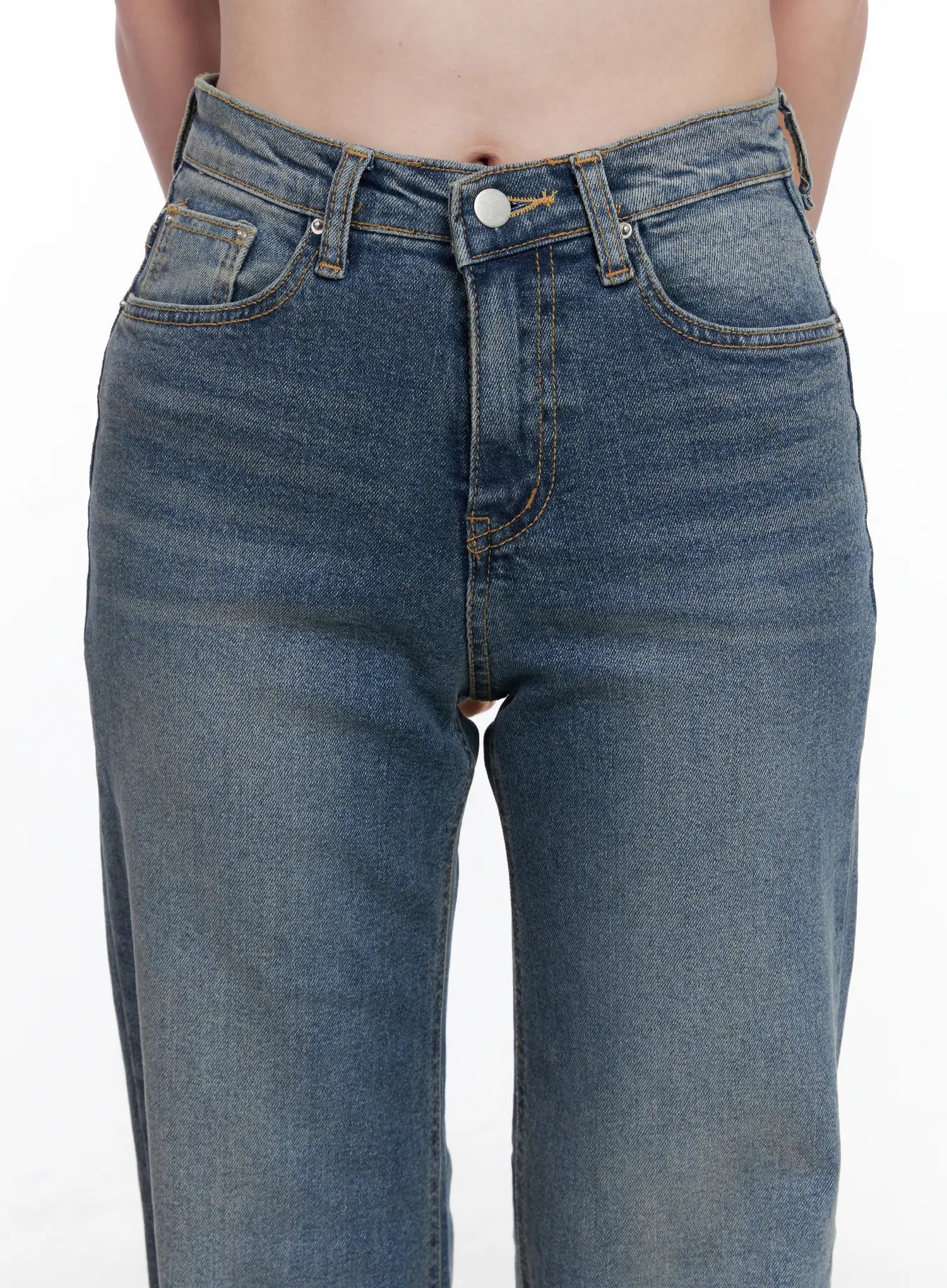 Juae High Waist Flare Jeans CG520 in blue, close-up of waistband and front pockets on model, gold stitching, button fly, washed denim texture.