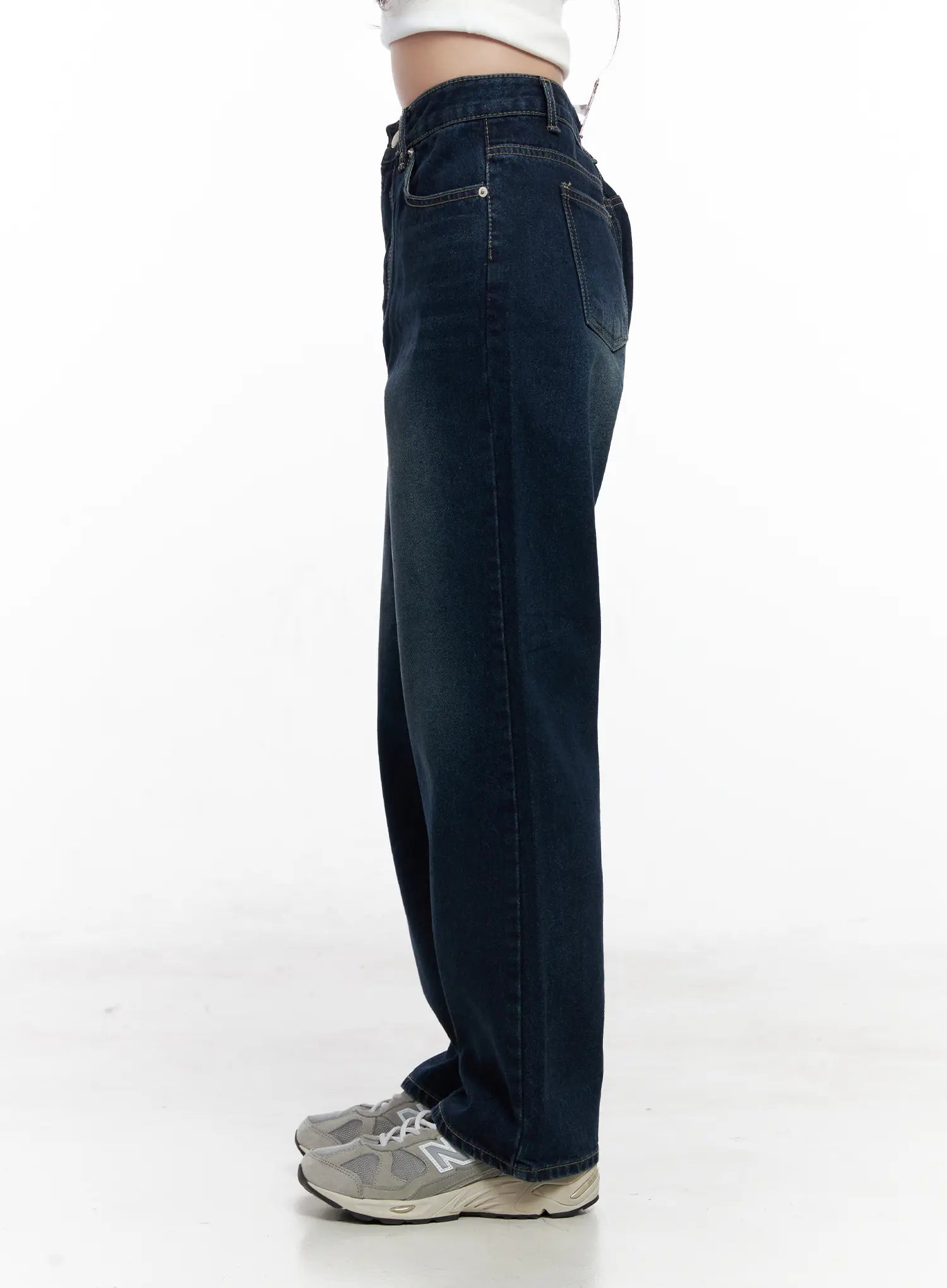 Shiloh Washed Semi-Wide Jeans CO524 in dark blue, side view on model, showing high-rise waistband, relaxed wide leg, and back pocket, paired with white crop top.