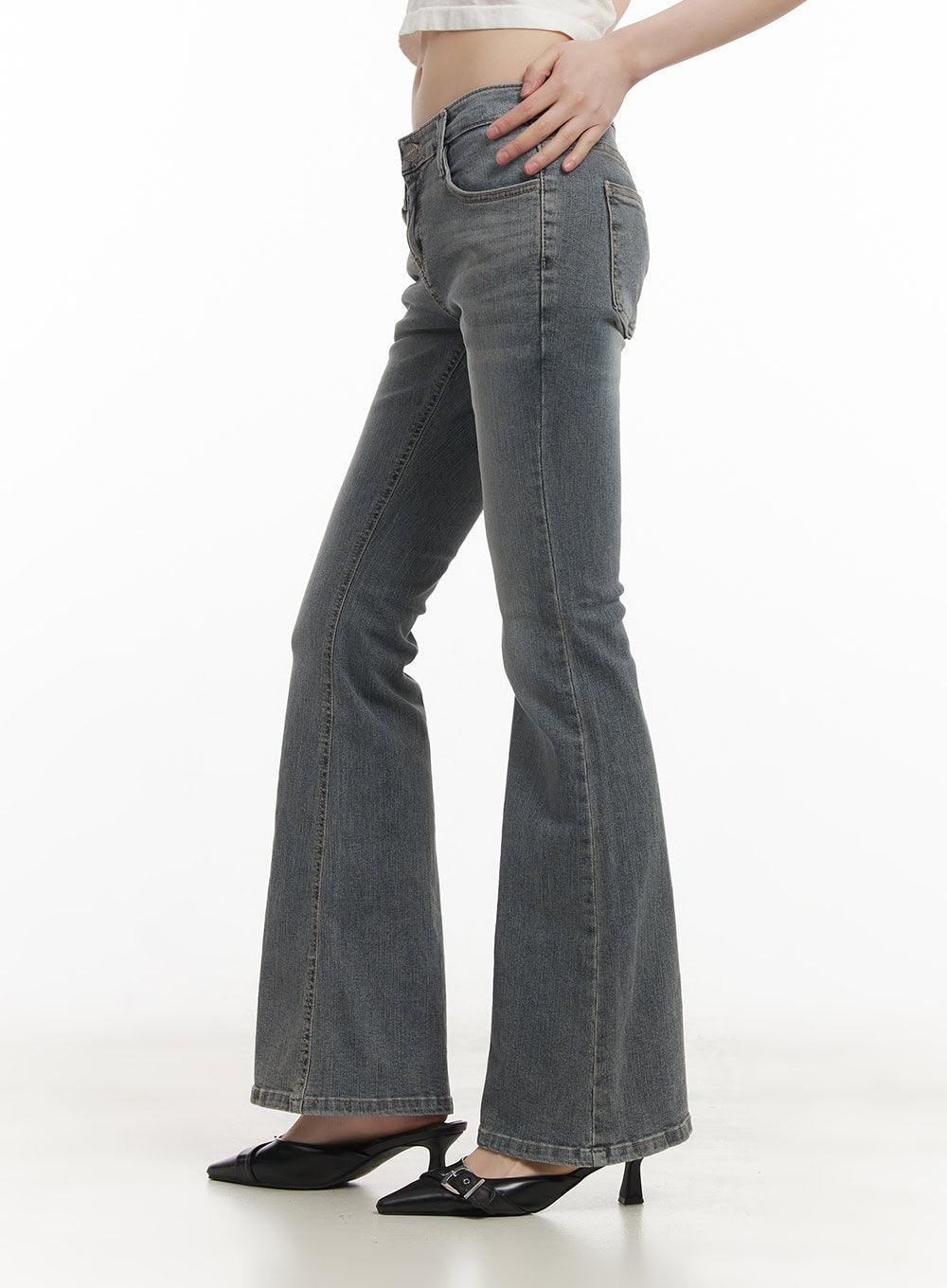 Rachel Washed Bootcut Jeans with Hip Pads CF518 in gray, side view on model, low-waist slim fit with bootcut flare leg and washed cotton denim, paired with black buckle heels.