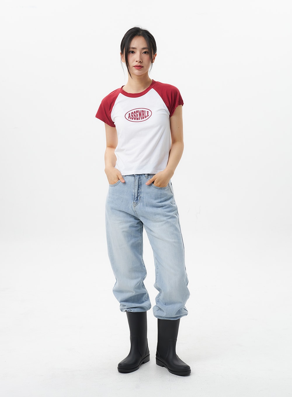 Wide Straight Leg Jeans OL304 in light blue, full-body front shot on model, hands in pockets, relaxed wide-fit denim with light wash, styled with crop raglan tee and black rain boots.