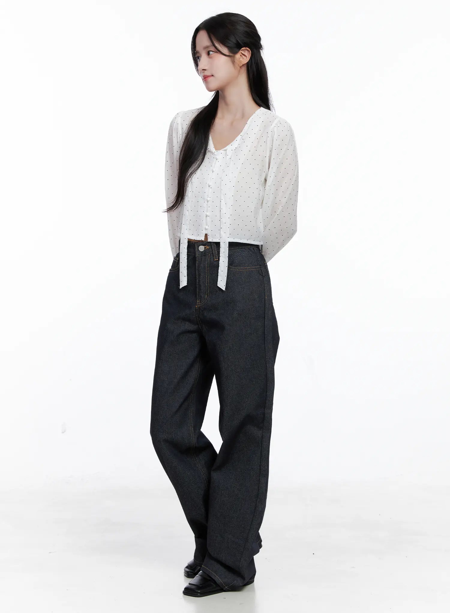 Reyna Non-Fade Relaxed Jeans CS519 in dark blue, three-quarter front worn by model, relaxed wide-leg cotton denim with gold stitch detail, styled with white polka-dot crop blouse, casual acubi look.