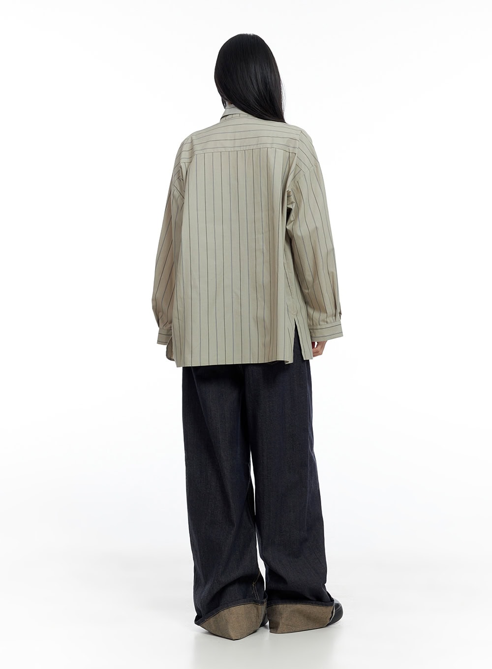 Sadie Roll-Up Denim Jeans CO426 in dark blue, back full-length view on model, wide-fit baggy denim with contrast khaki roll-up hem, styled with striped oversized shirt.