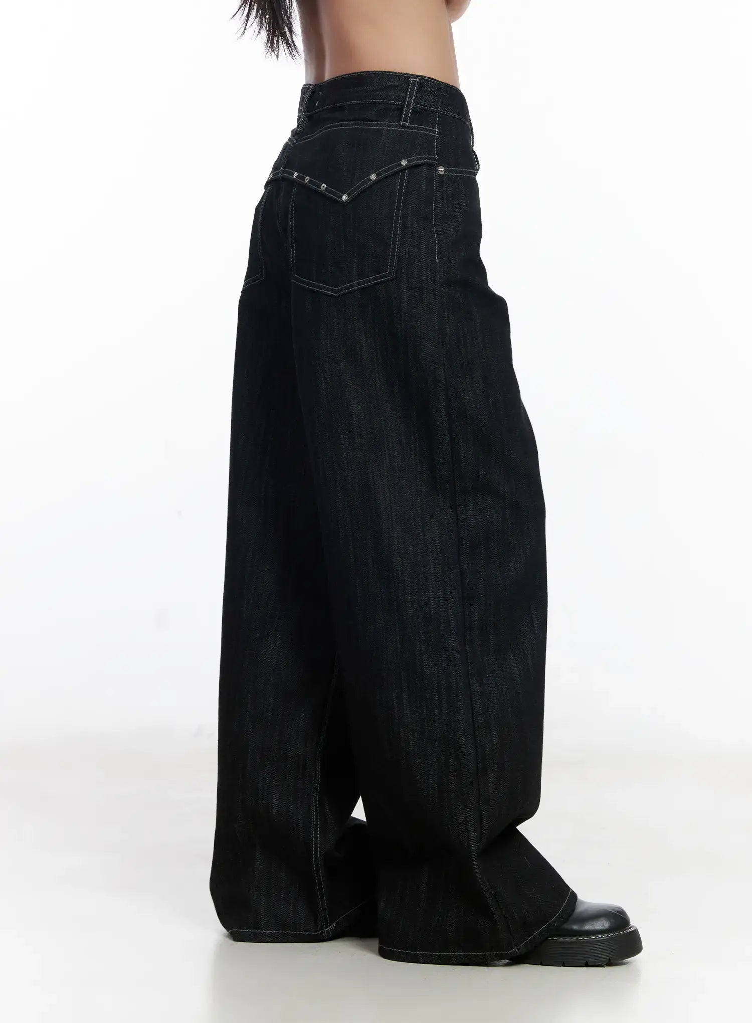 Violet Studded Baggy Jeans CJ530 in black, side view on model, wide-leg cotton denim showing silver stud detail along back yoke, deep wide leg and contrast stitching, black chunky loafer.