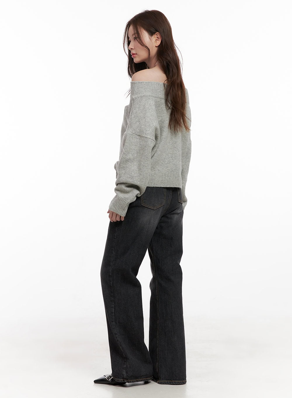 Kiana Cotton Wide Fit Flared Jeans OD403 in black, side-back view on model, washed cotton wide-fit flare with back pockets visible, styled with grey off-shoulder knit and black buckle heels.